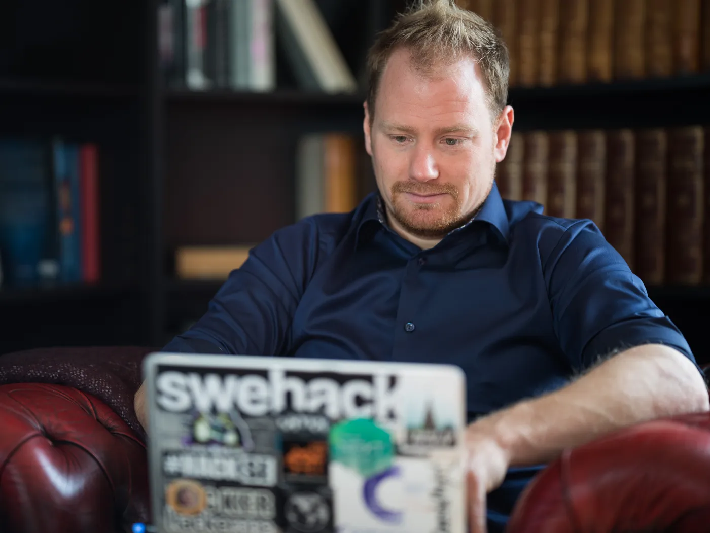 David Jacoby working on a sticker-covered laptop